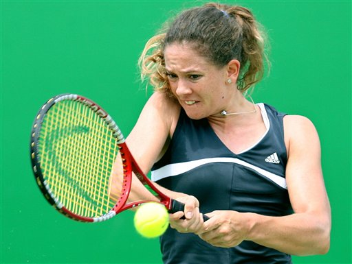 Patty Schnyder of Switzerland hits a backhand in her first round match against Eleni Daniilidou of Greece during day two of the Australian Open at Melbourne Park January 17, 2006 in Melbourne, Australia