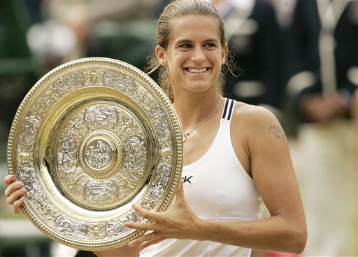 France's Amelie Mauresmo holds the Championship plate, after defeating Belgium's Justine Henin-Hardenne in the Women's Singles final on the Centre Court at Wimbledon, Saturday July 8, 2006.