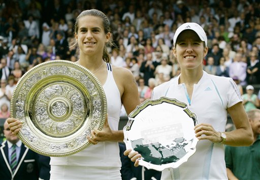 France's Amelie Mauresmo, left, holds the Championship plate, and Belgium's Justine Henin-Hardenneholds the runners-up trophy, after the Women's Singles final on the Centre Court at Wimbledon, Saturday July 8, 2006