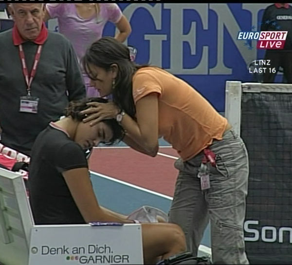 Eleni Daniilidou (R) of Greece receives medical treatment during her second round tennis match against Maria Sharapova of Russia at the Generali Linz tennis tournament in Linz October 26, 2006. 