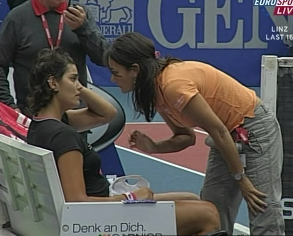 Eleni Daniilidou (R) of Greece receives medical treatment during her second round tennis match against Maria Sharapova of Russia at the Generali Linz tennis tournament in Linz October 26, 2006. 