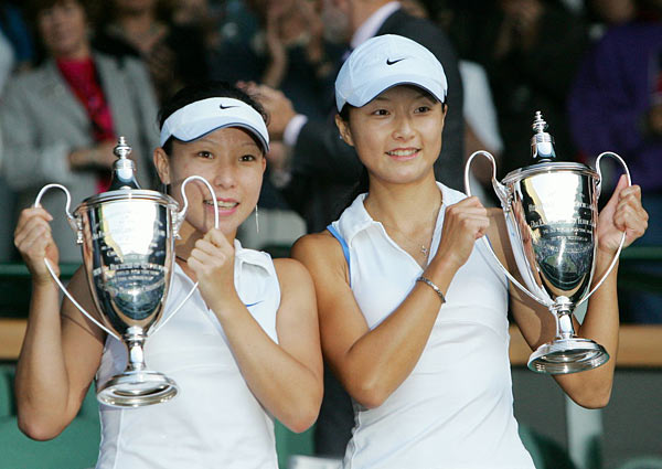 Yan Zi, right, and Zheng Jie of China hold their Women's Doubles Championship trophies on the Centre Court at Wimbledon, Sunday July 9, 2006. 