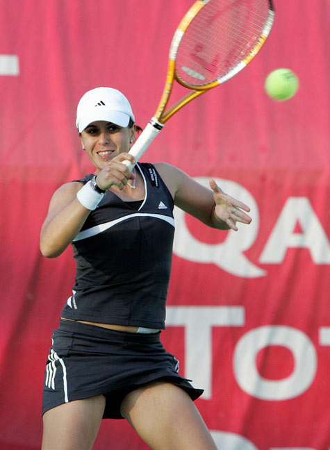 Anabel Medina Garrigues of Spain returns the ball to Eleni Daniilidou of Greece during the second day of the WTA Qatar Open tennis tournament in Doha February 28, 2006